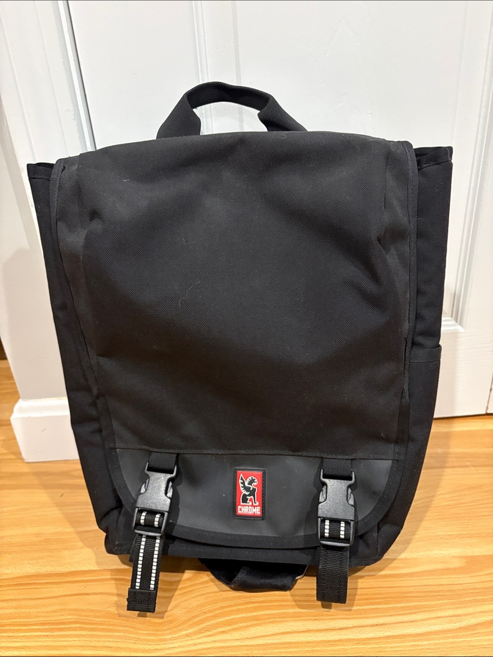 Chrome Industries brand Black Messenger Backpack with seatbelt style buckle
